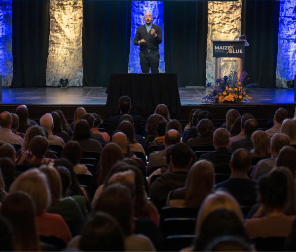 Keynote speaker Marcus Collins speaks to the crowd from the podium